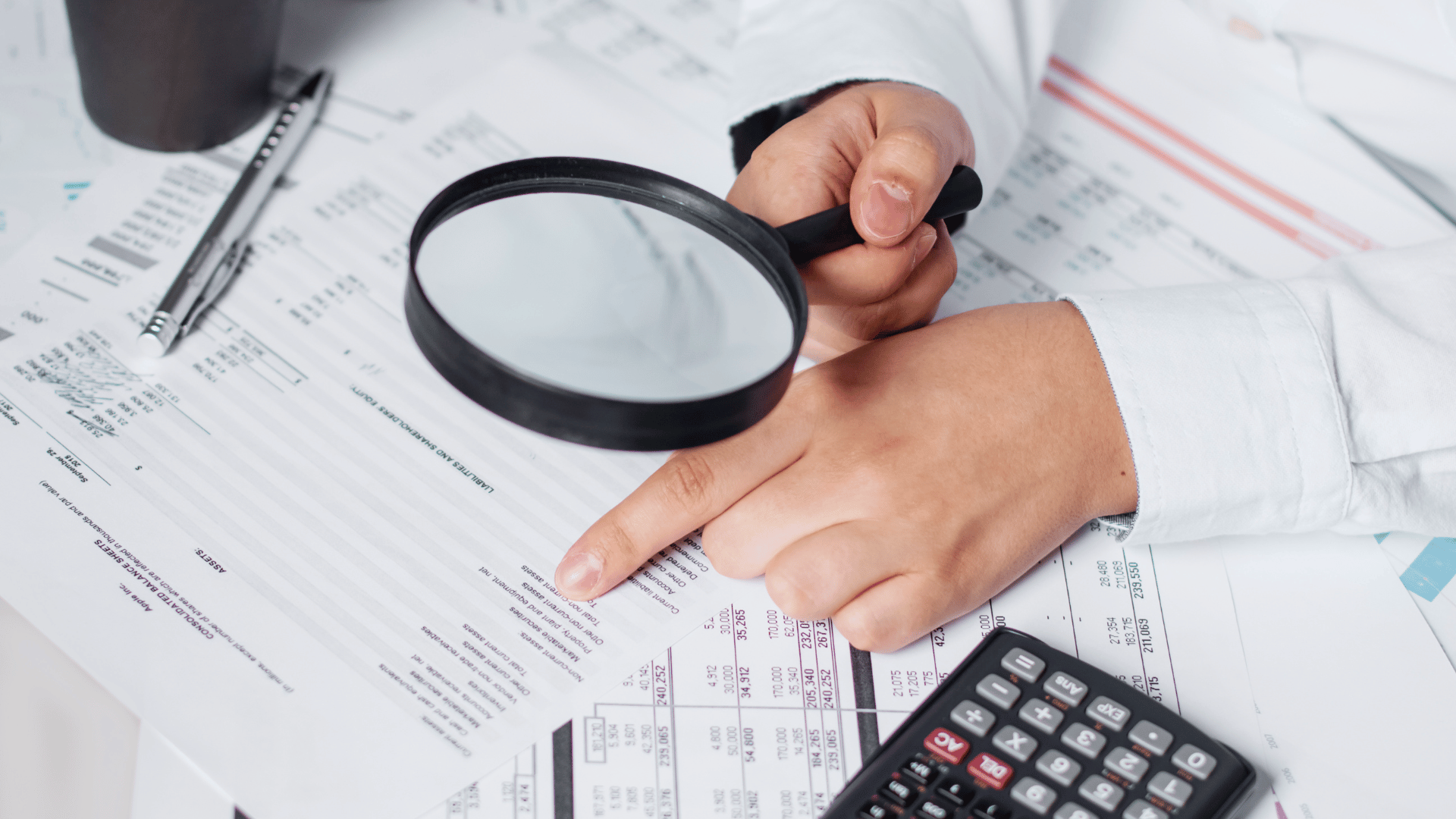 Arizzon team member reviewing documents during an audit between the client and auditor.